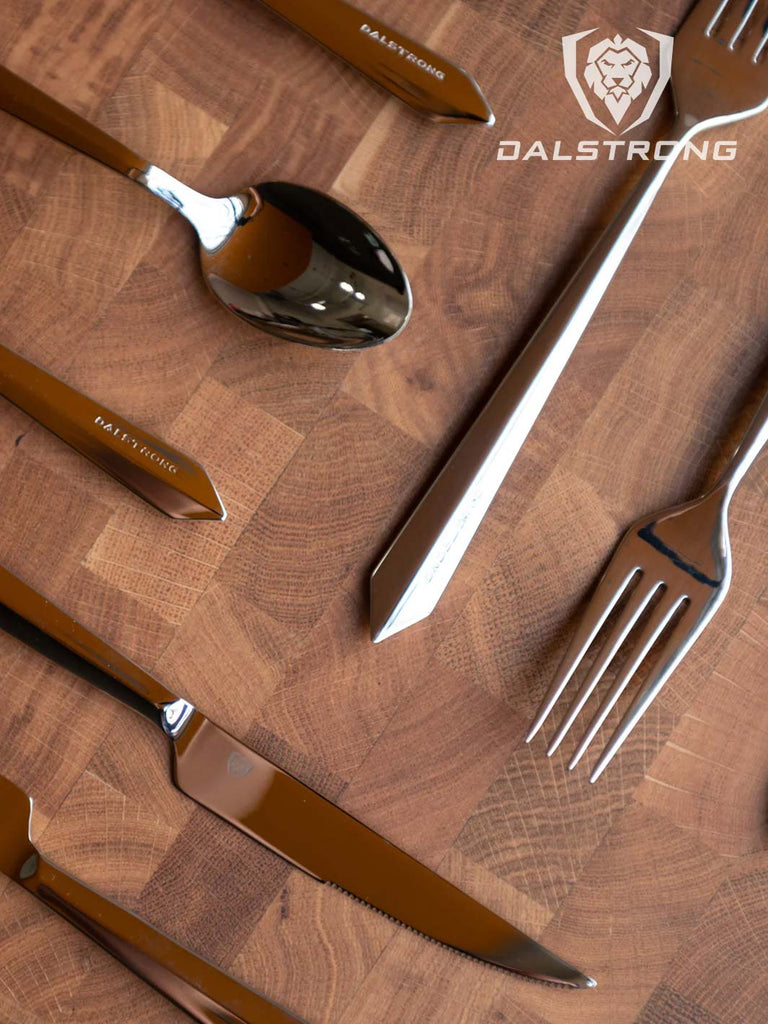 20-Piece Flatware Cutlery Set | Silver Stainless Steel | Service for 4 | Dalstrong on top of a dalstrong cutting board.