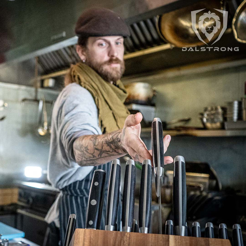 A man reaching a knife from the 18 Piece Colossal Knife Set with Block Gladiator Series Knives NSF Certified