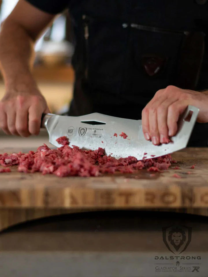 A man chopping meat using the Gladiator Series Rocking Cleaver Knife 12"