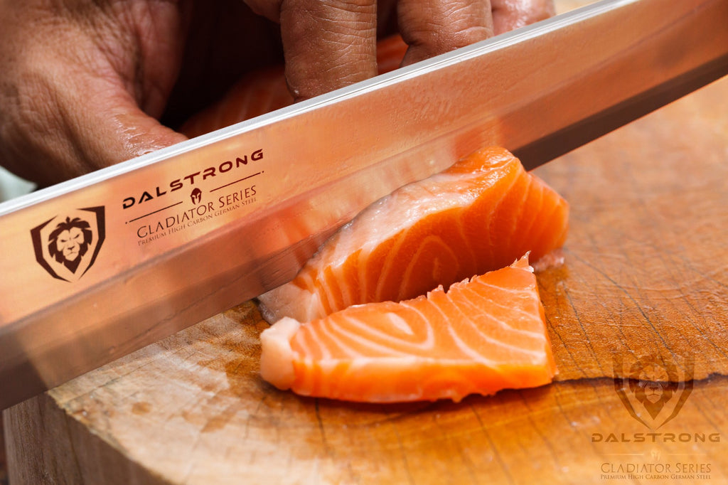Stainless Steel yanagiba knife slicing through raw fish on a wooden cutting board