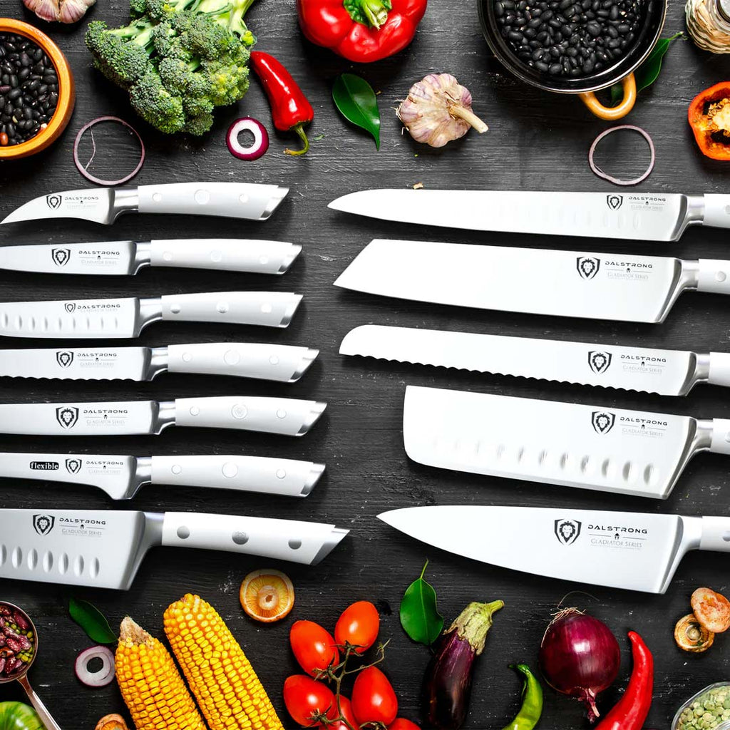 A photo of the 18-piece Colossal Knife Set with Block | White Handles | Gladiator Series | Knives NSF Certified | Dalstrong with different kinds of vegetables.