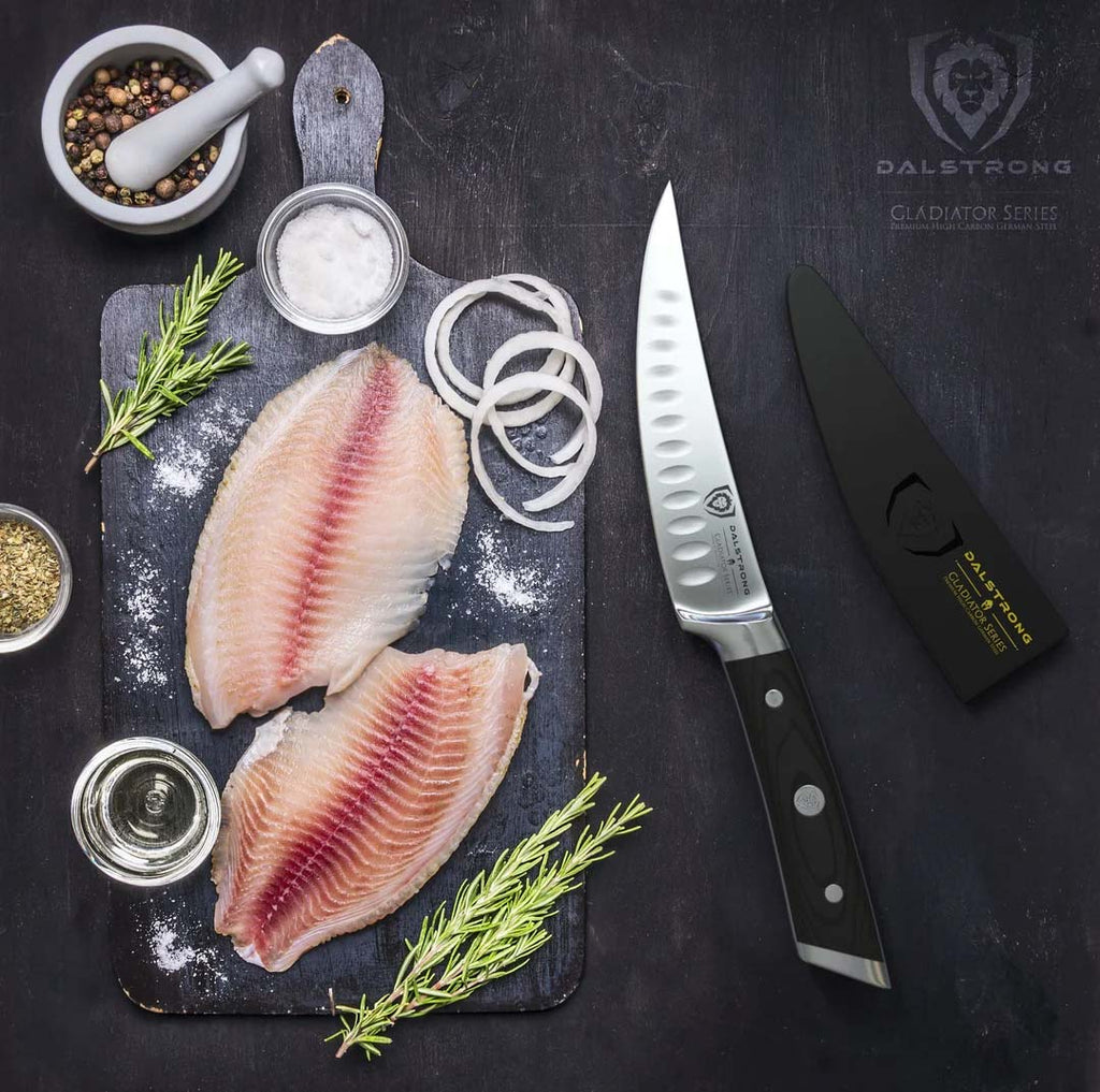 A photo of the Curved Fillet Knife 6" Gladiator Series | NSF Certified | Dalstrong with two fillet fish on top of a wooden board.