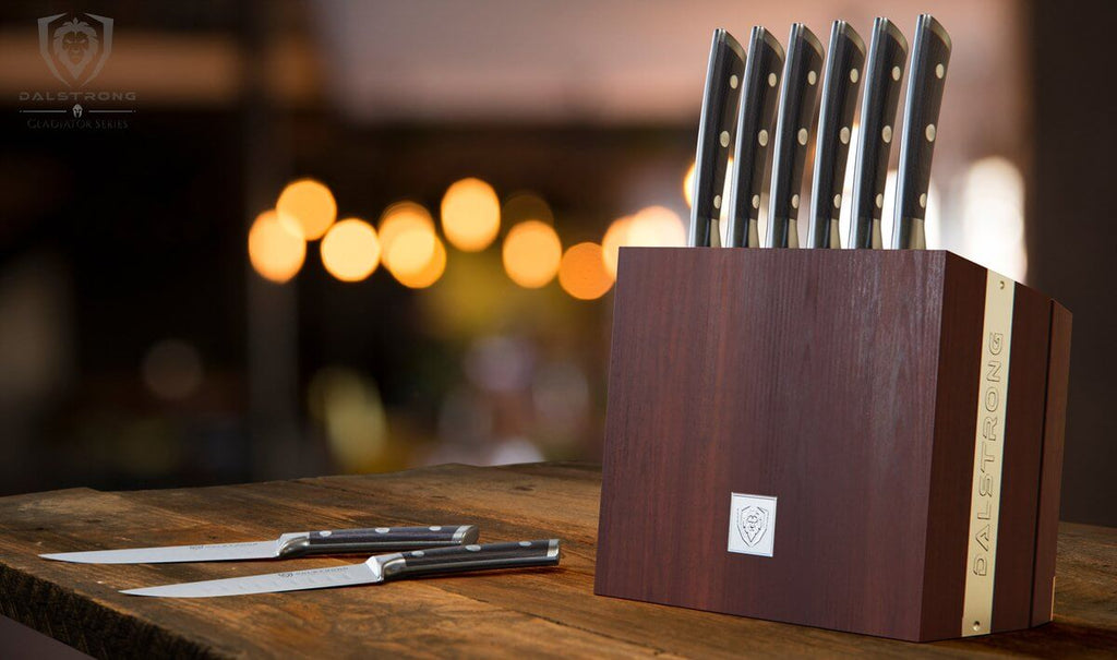 Storage block with eight steak knives on a kitchen counter