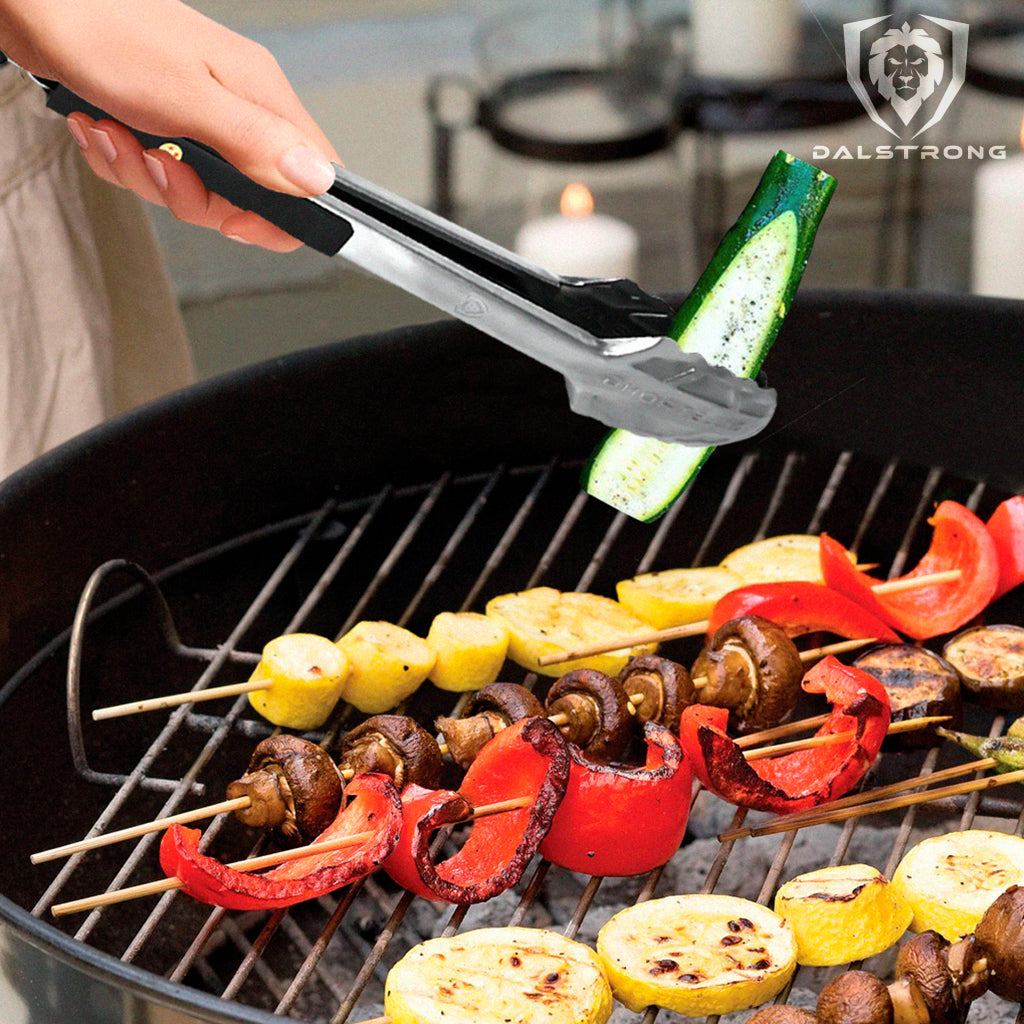 A pair of tongs lifting a vegetable from a bbq grill 
