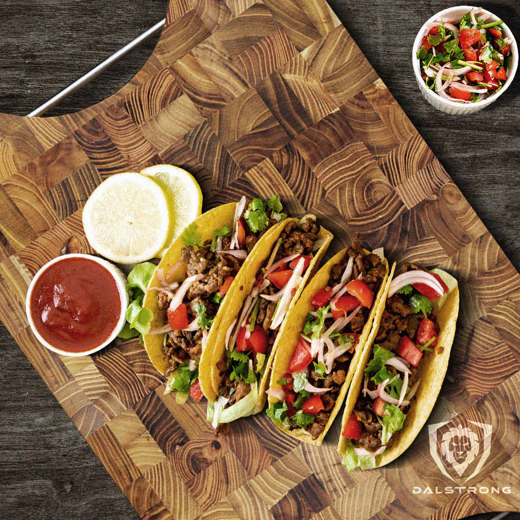 Freshly made ground beef taco on top of a Dalstrong teak cutting board with sauces on the side.