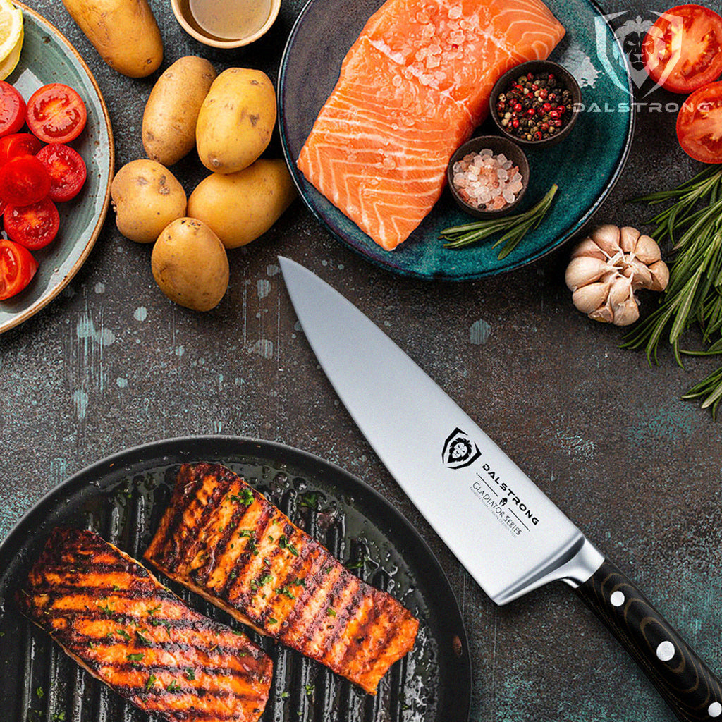 Grilled salmon with vegetables and chef's knife laying on counter