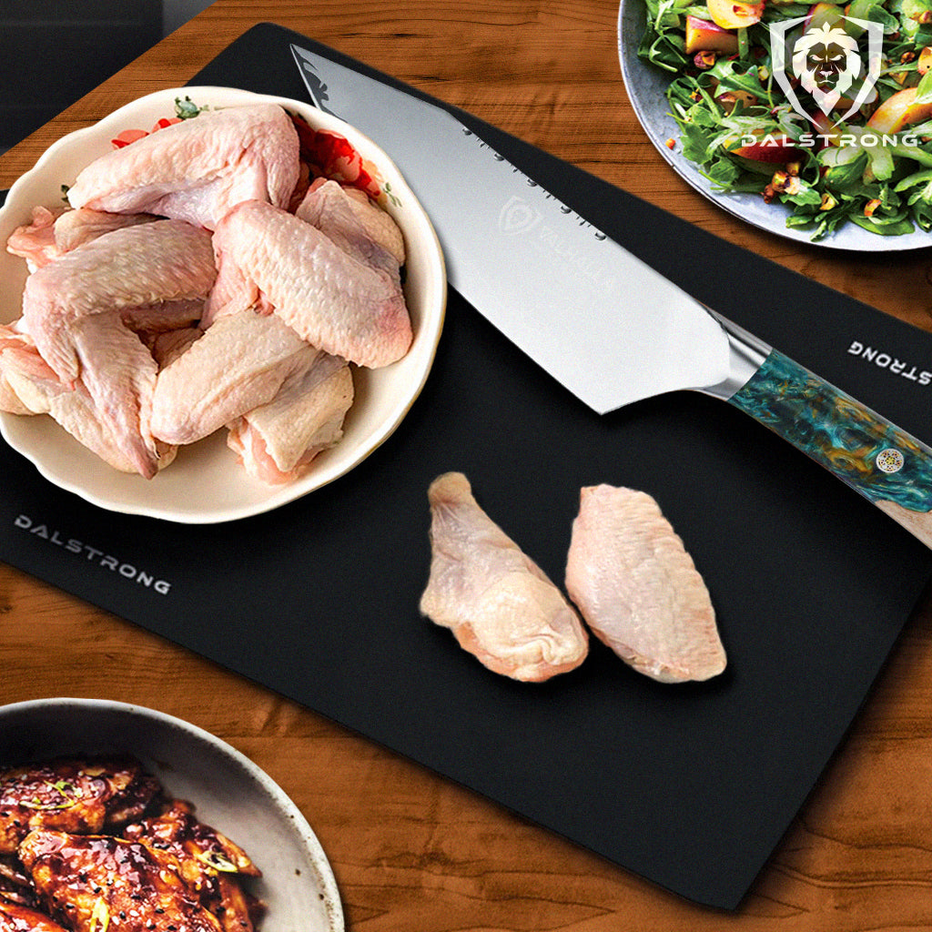 bowl of wings on cutting board beside chef's knife