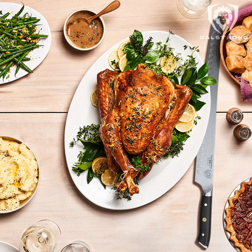 A cooked turkey covered in garnish on a white plate next to a long carving knife