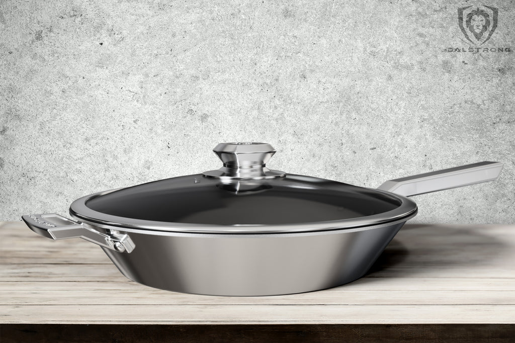 Stainless Steel Pan On A Light Brown Table with a grey wall for a background