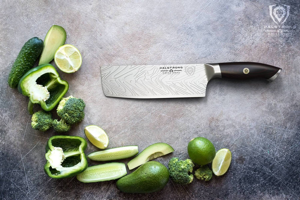 A pile of green vegetables arranged to spell the letter L next to a nakiri knife 