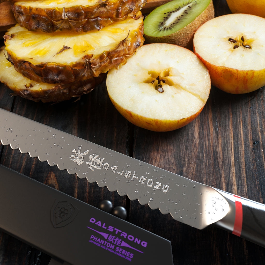 Sharp serrated knife on a wooden surface next to a pile of fruit 