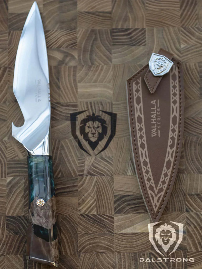 Valhalla Series BBQ Piranha Knife 6" beside it's sheath on a dalstrong cutting board.