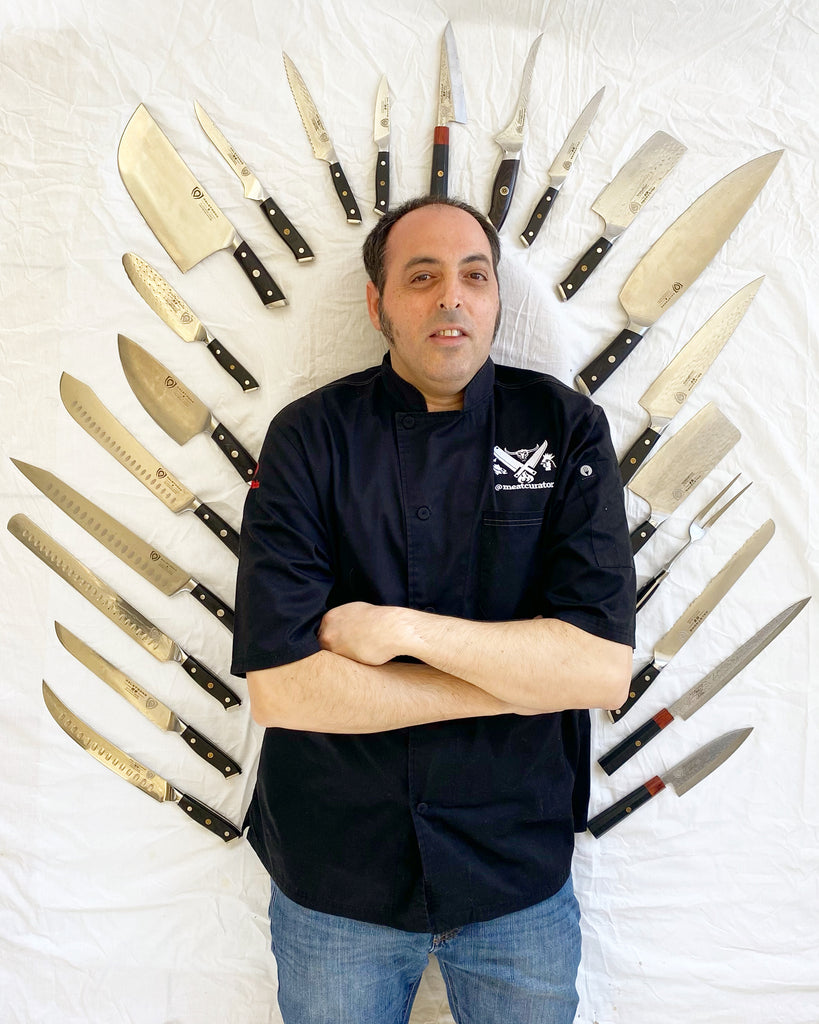 Chef Ruben Maislos @meatcurator poses with twenty two Dalstrong Chef knives surrounded him