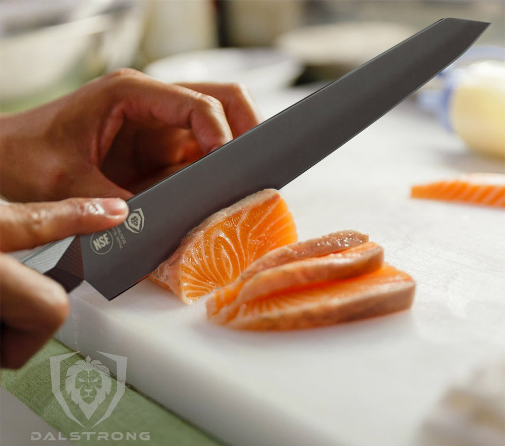 A Dalstrong Yanagiba Sushi Knife cutting into a piece of raw fish