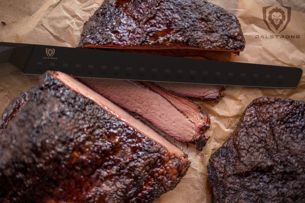 Smoked brisket with burnt ends sliced on a cutting board with a black carving knife 