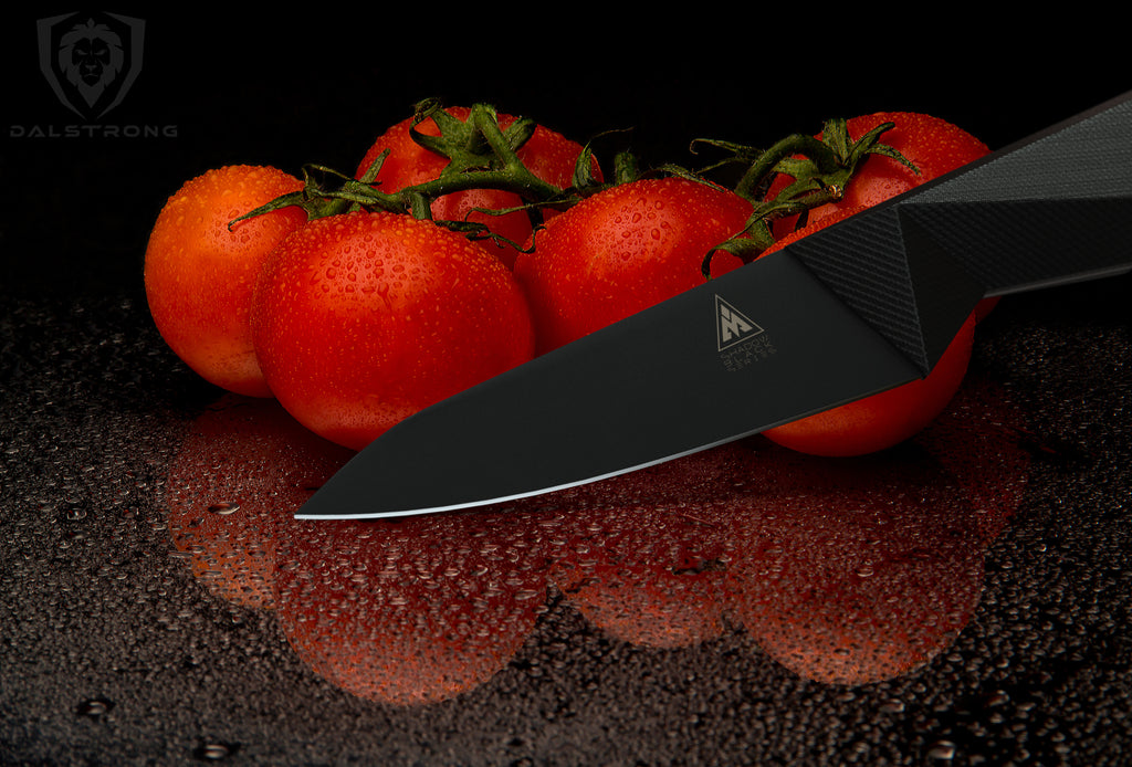 Close-up shot of the Dalstrong Shadow Black Series 3.75" Paring Knife with fresh tomatoes at the back.