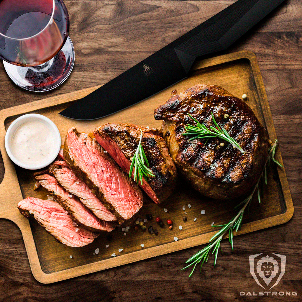 Sliced cooked steak on a wooden cutting board next to a steak knife