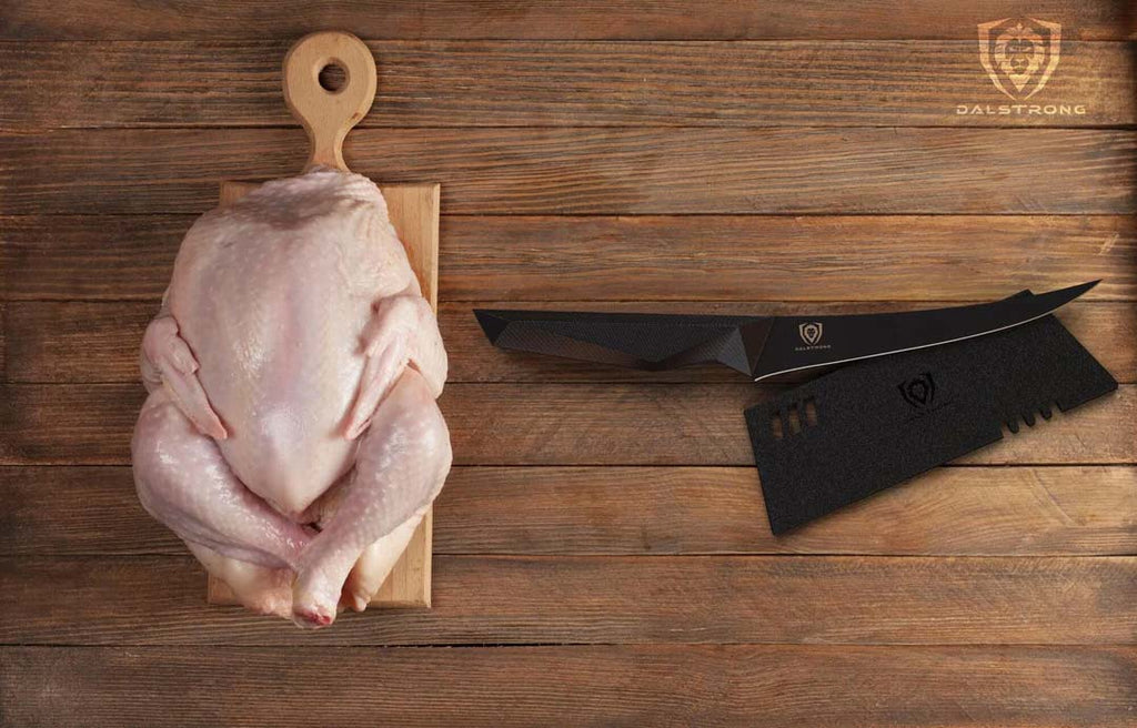 A photo of the Curved Boning Knife 6" | Shadow Black Series | NSF Certified | Dalstrong with one whole chicken on top of a wooden board.