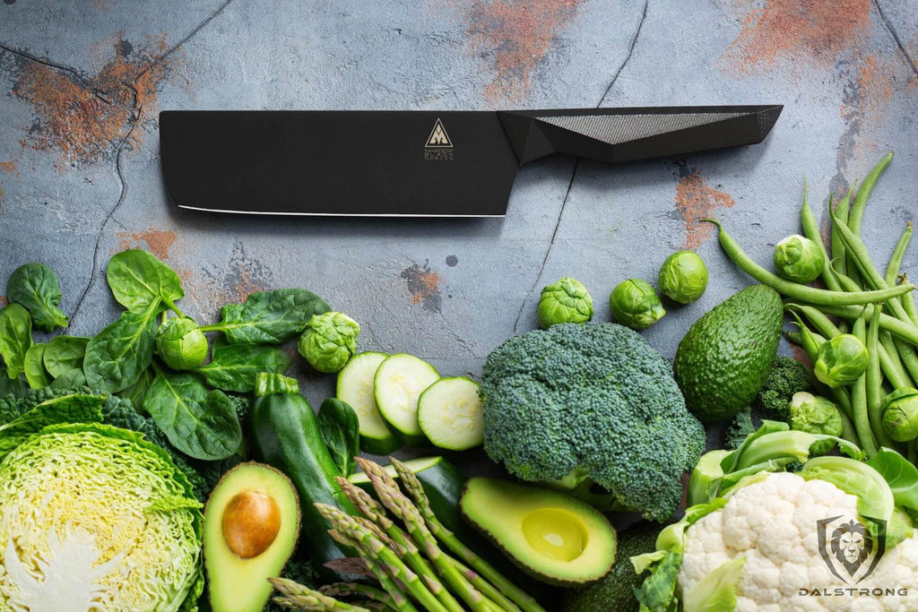 shadow black series nakiri knife laying on rustic table with raw vegetables