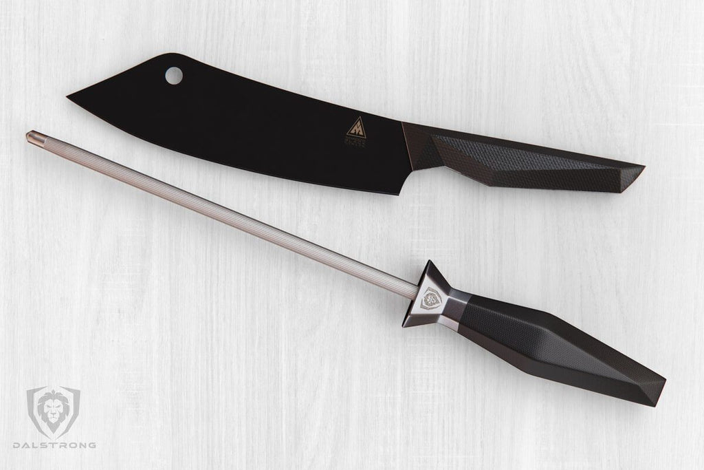 Black cleaver knife on a white surface next to a honing steel rod