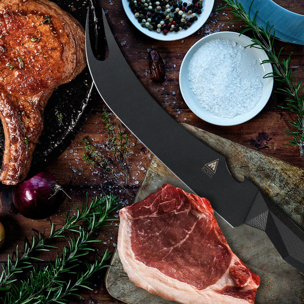 A cooked pork chop next to an uncooked piece of meat that is beside a black bbq knife with a fork tip