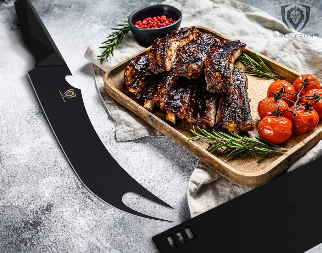 Fork tipped butcher knife on white surface next to a tray of bbq ribs 