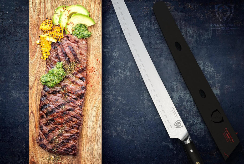 A narrow cutting board with cooked meat next to a long carving knife against a black backdrop