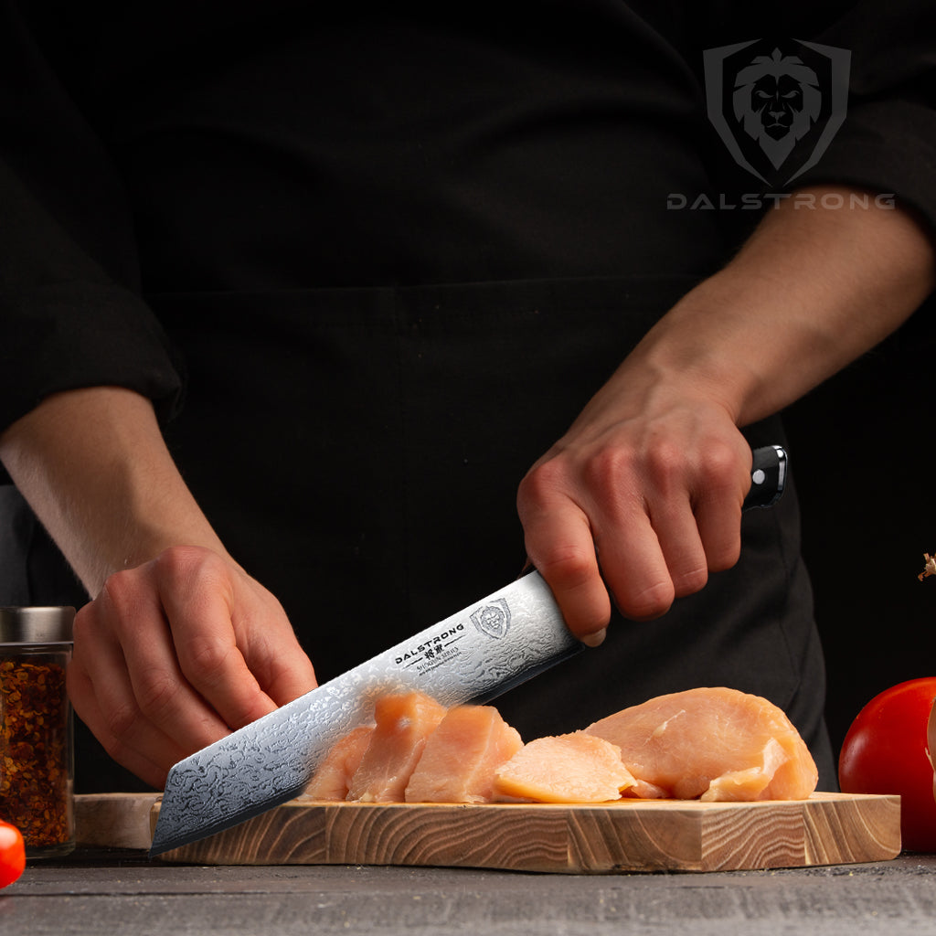 Chef slicing chicken with Kiritsuke 