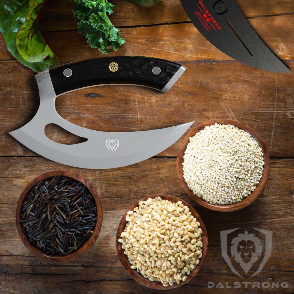 ulu knife laying on counter beside spices and herbs