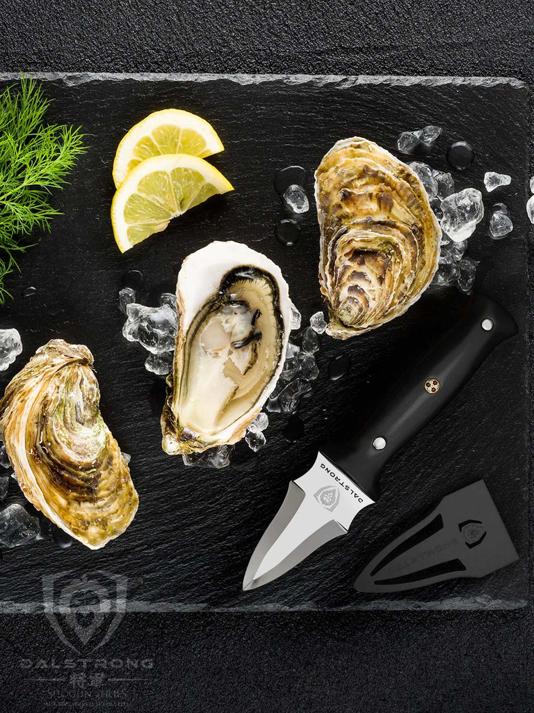 Professional Oyster & Clam Shucking Knife 3.5" | Shogun Series ELITE | Dalstrong beside opened oysters.