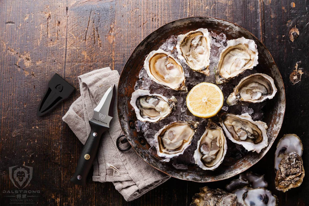 A large plate of eight oysters and garnish on a wooden counter next to an oyster knife