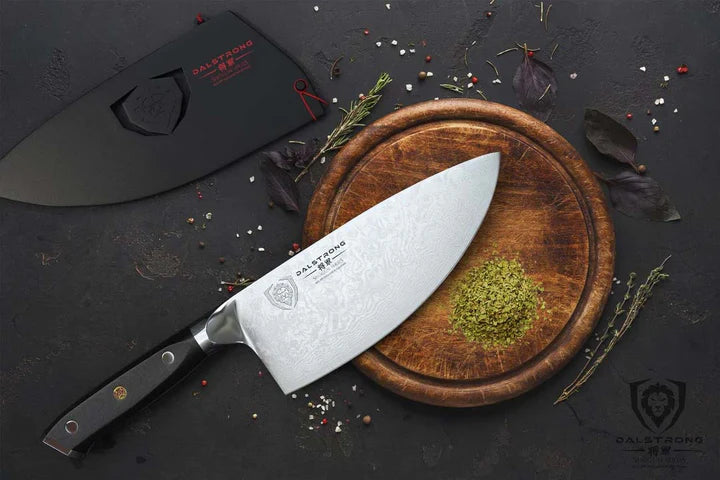 Shogun Series Elite Rocker Knife 7" beside a cutting board with herbs.