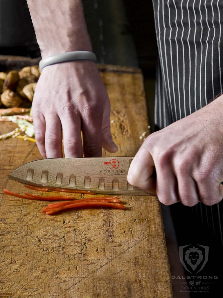 A photo of a mans hand slicing bell pepper using the Santoku Knife 7" | Shogun Series ELITE | Dalstrong