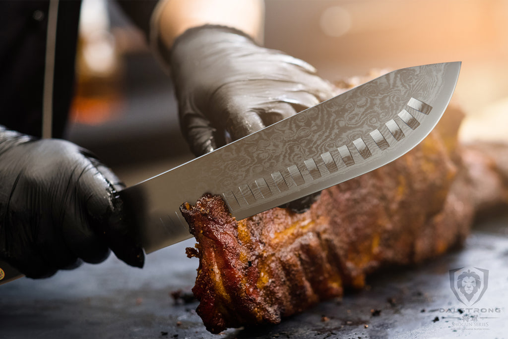 A man using black gloves slices through a rack of meat with a silver butcher knife