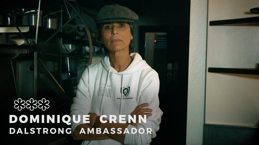Dominique Crenn Poses in a Dalstrong Hoodie with subtitles stating her status as a Michelin chef and Dalstrong ambassador 