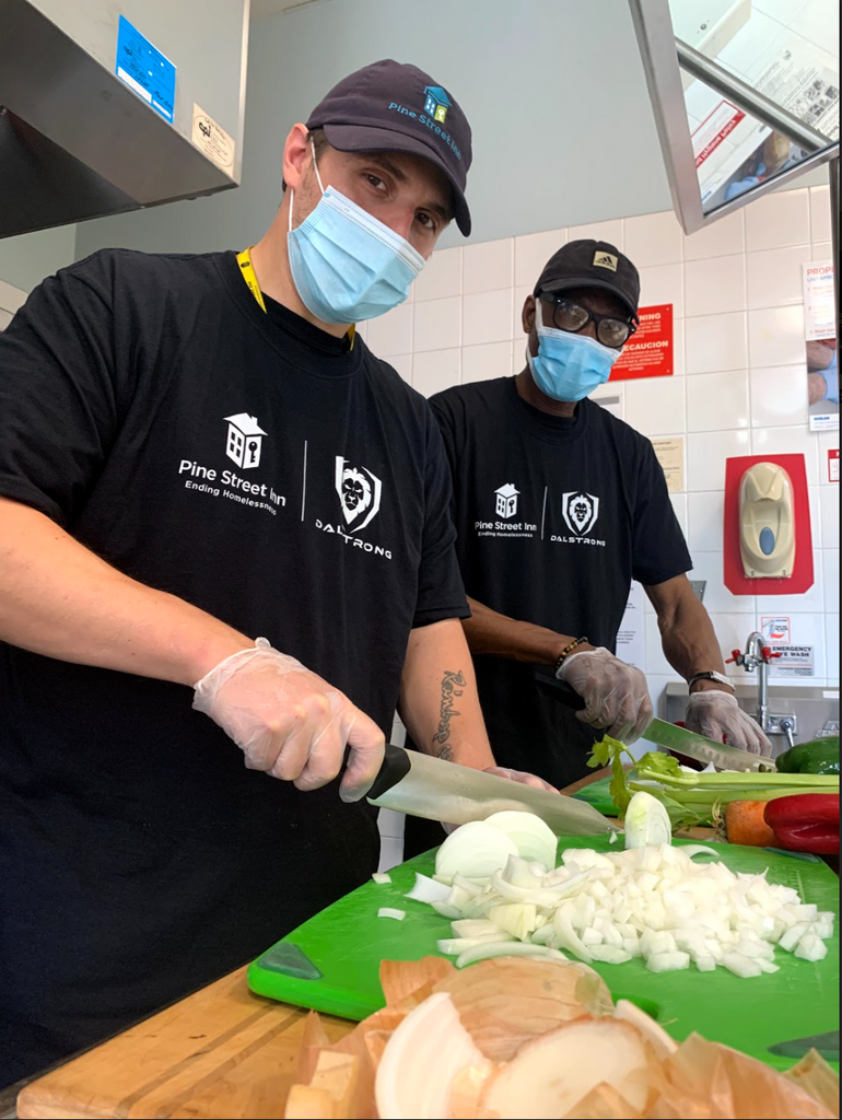 Two iCater trainees chopping vegetables