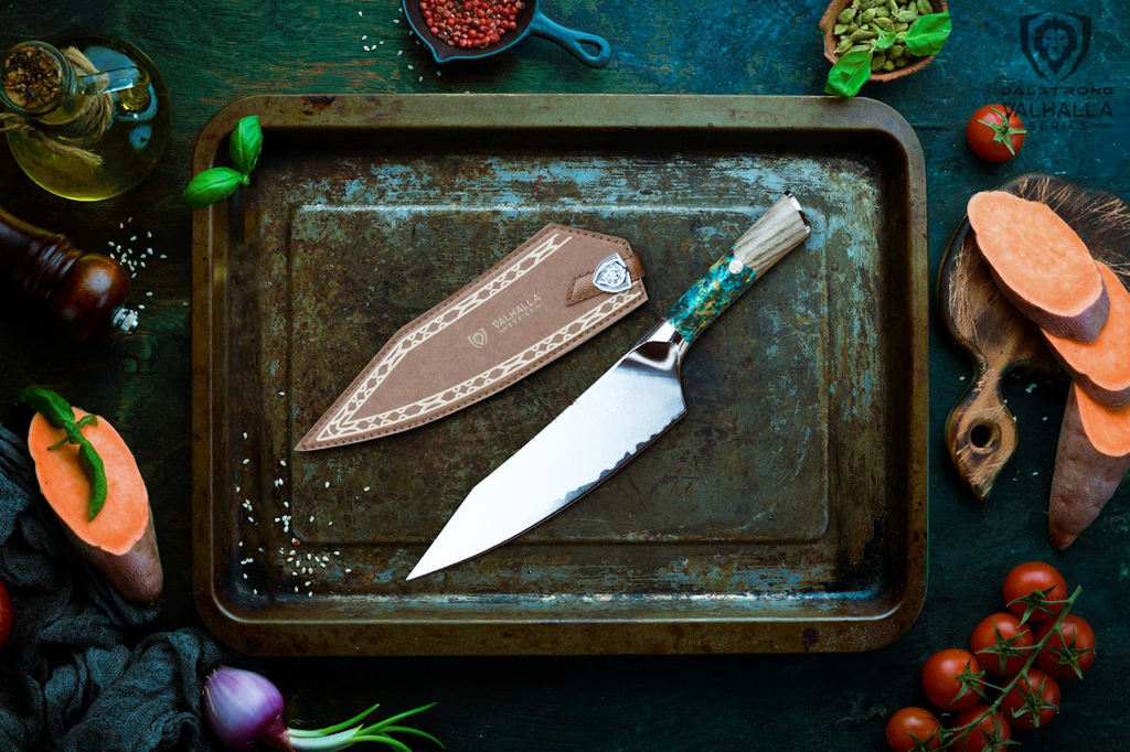 A photo of the Chef's Knife 8" Valhalla Series Dalstrong with the sheath beside inside an old iron tray.