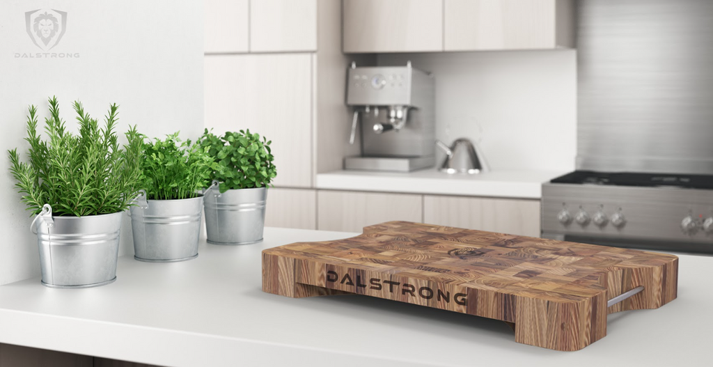 A photo of the Lionswood Teak Cutting Board Medium Size Dalstrong on top of a kitchen table.
