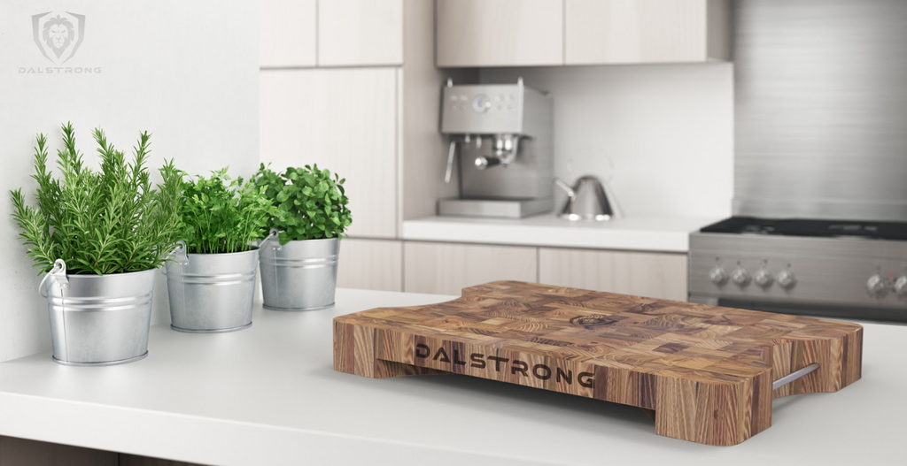 A photo of the Lionswood Teak Cutting Board Dalstrong in top of a white table.