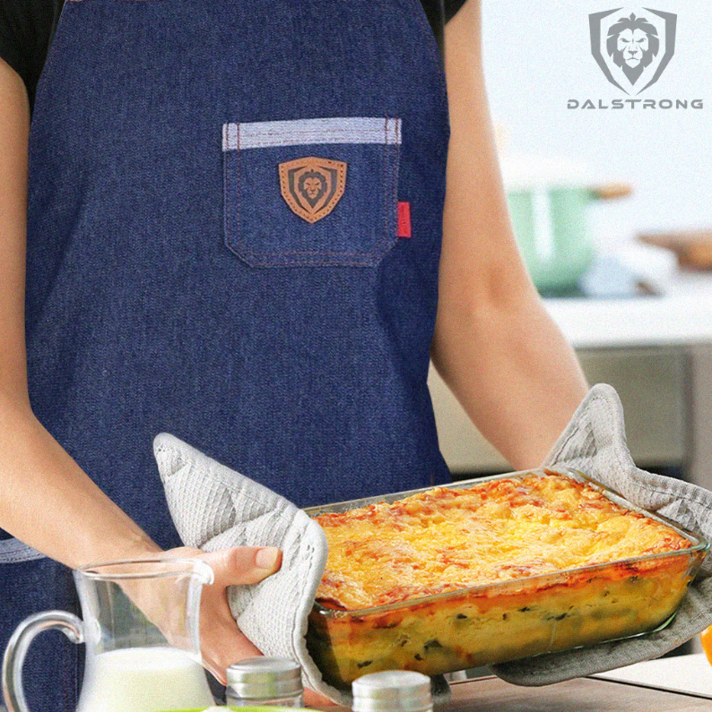 A man using Dalstrong Professional Chef's Kitchen Apron - American Legend holding a mac and cheese