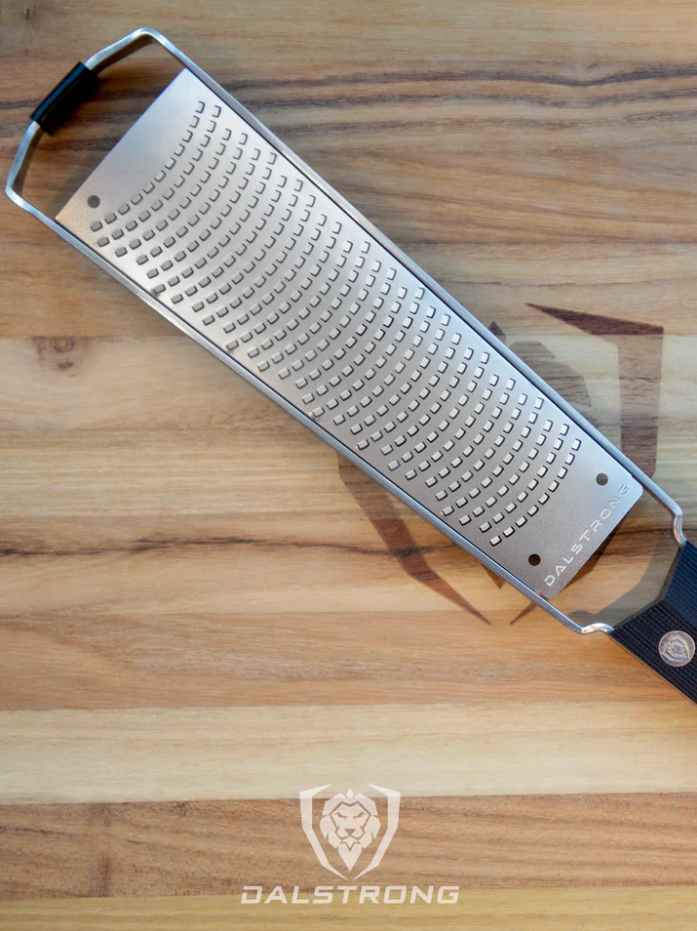 A photo of the Dalstrong Professional Zester Narrow Grater on top of the Dalstrong wooden board