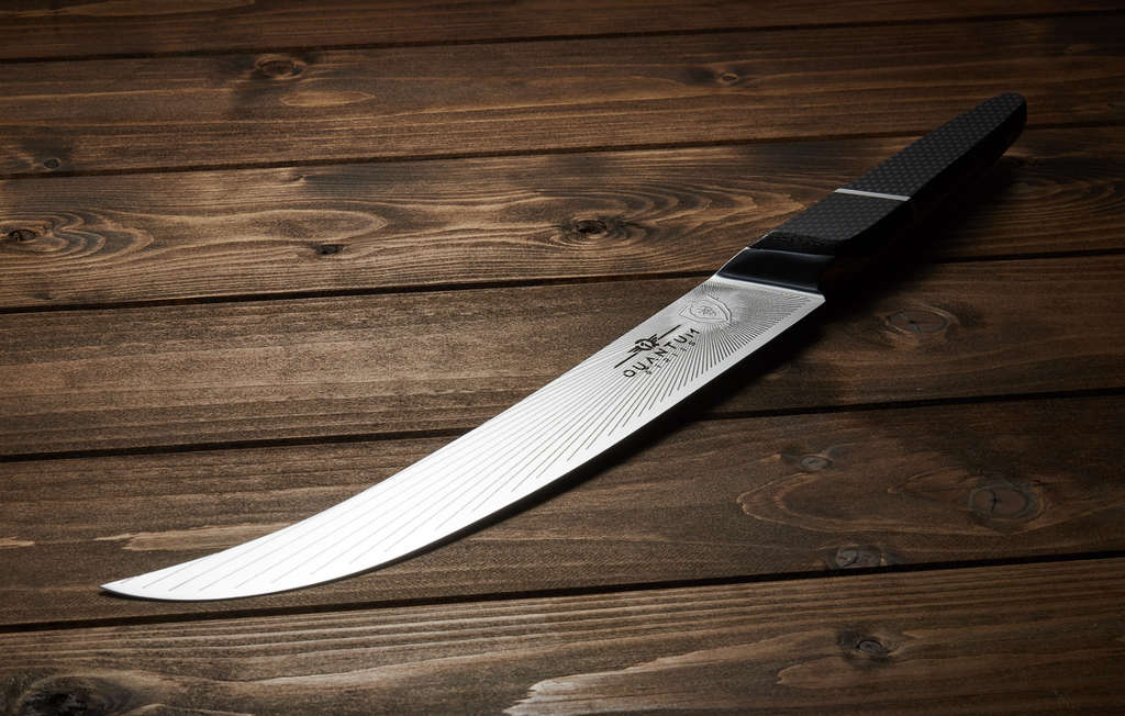 A photo of the Butcher & Breaking Knife 10" Quantum 1 Series Dalstrong on a wooden table