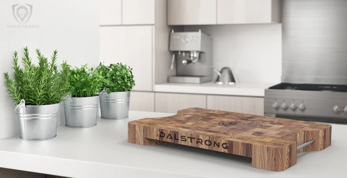 A photo of the Lionswood Teak Cutting Board Dalstrong in top of a white table.