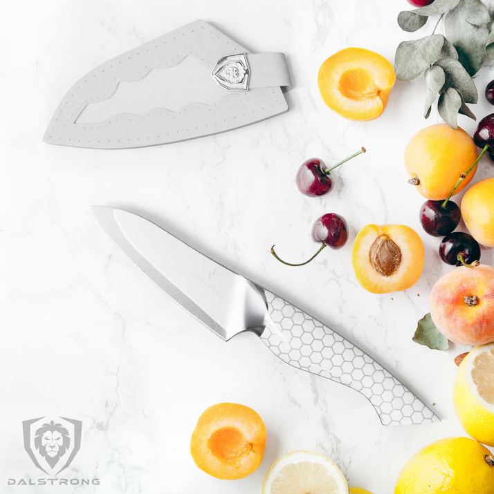 A photo of the Paring Knife 3.5" Frost Fire Series NSF Certified Dalstrong with fresh fruits around it on a white surface