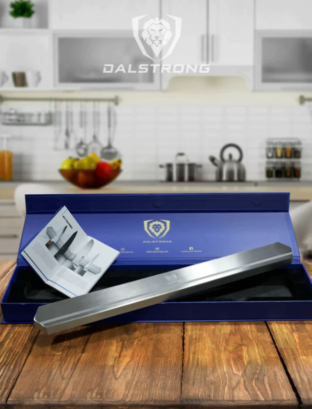 A photo of the Magnetic Bar Stainless Wall Knife Holder Dalstrong with its box on top of a wooden table