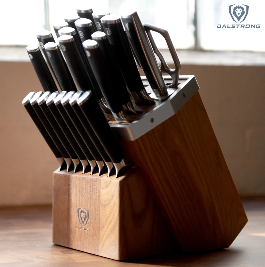 A close-up shot of the Dalstrong Vanquish Series 24-Piece Knife Block Set on a wooden table.