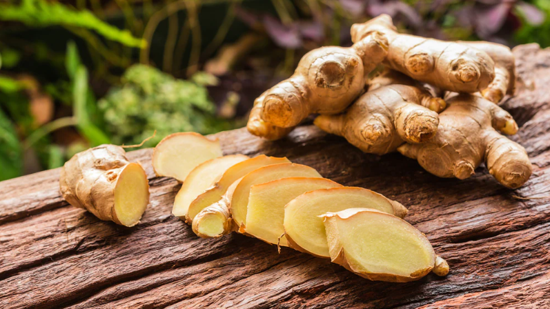 sliced ginger root on top of a tree trunk