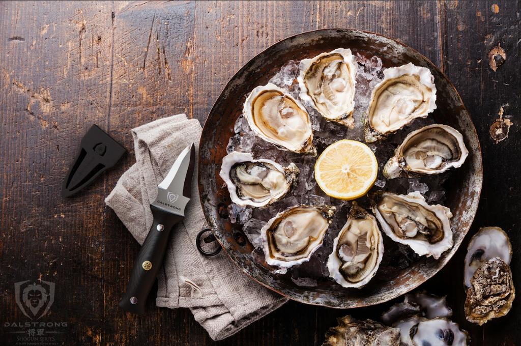 A photo of the Professional Oyster & Clam Shucking Knife 3.5" Shogun Series ELITE | Dalstrong with eight shucked oysters on top of a wooden table.