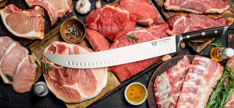 A photo of the Dalstrong butcher knife laying on top of assorted meats.