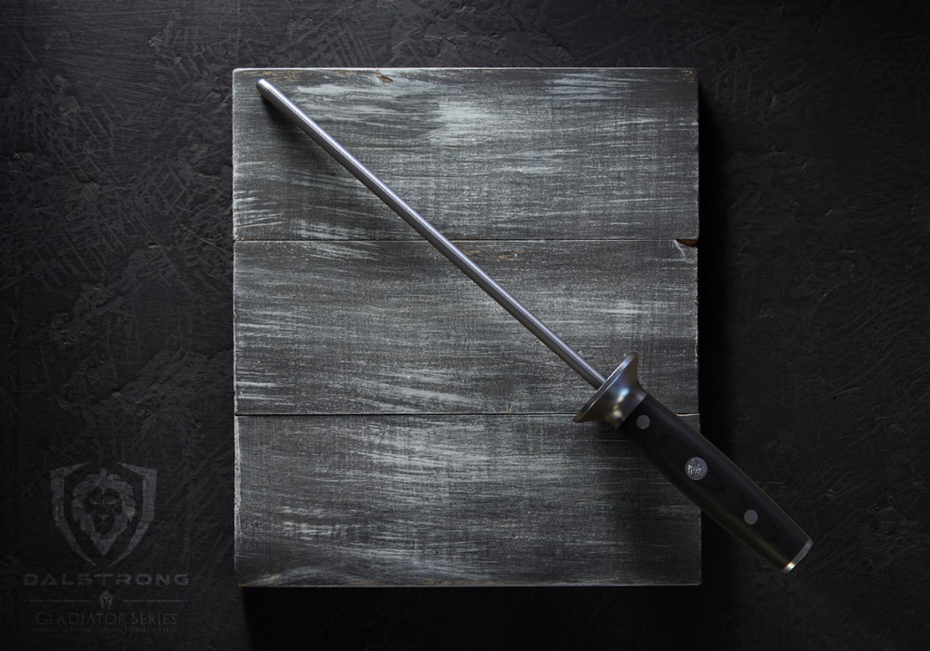 A photo of the Honing Steel 10" Gladiator Series | NSF Certified | Dalstrong on top of a wooden board.